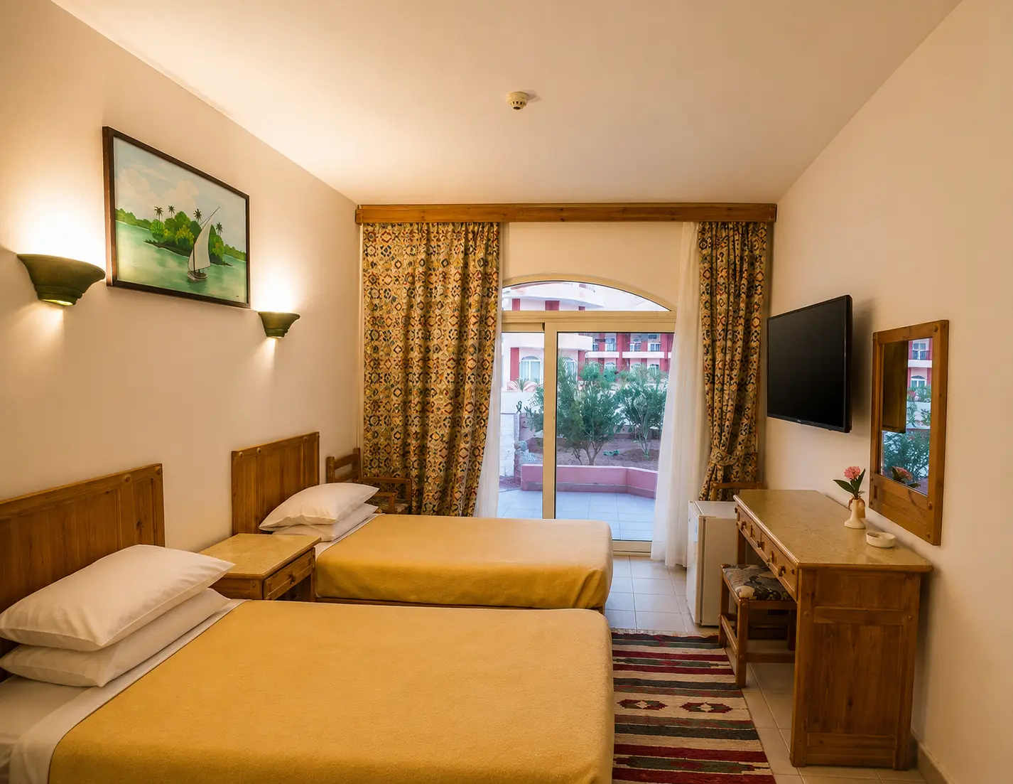 Twin room with a terrace door opening onto the gardens