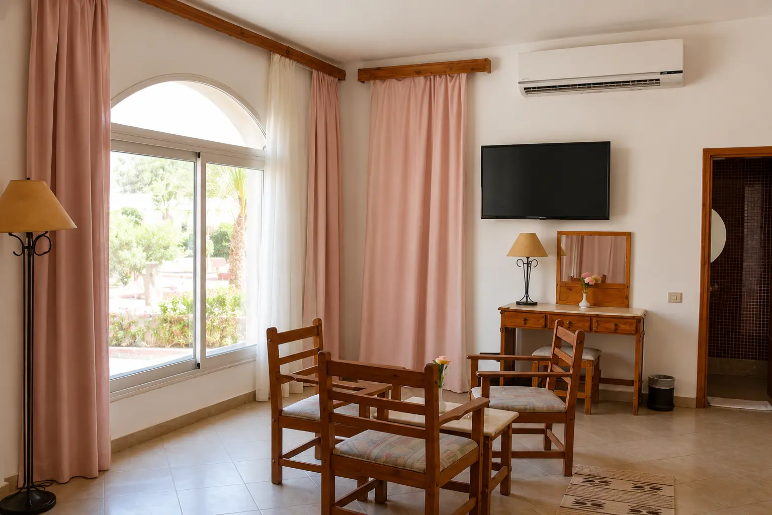 Suite sitting area with arched window over the gardens